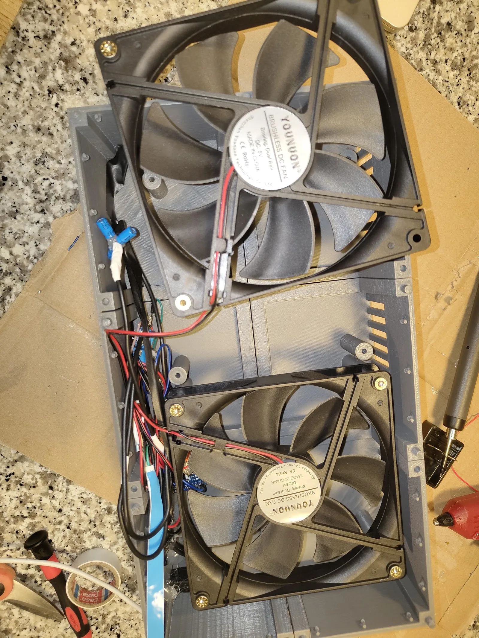Cooling fans mounted inside the fireplace